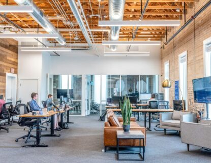 Modern office workspace with teams working at computers, focused on digital outreach and lead generation.